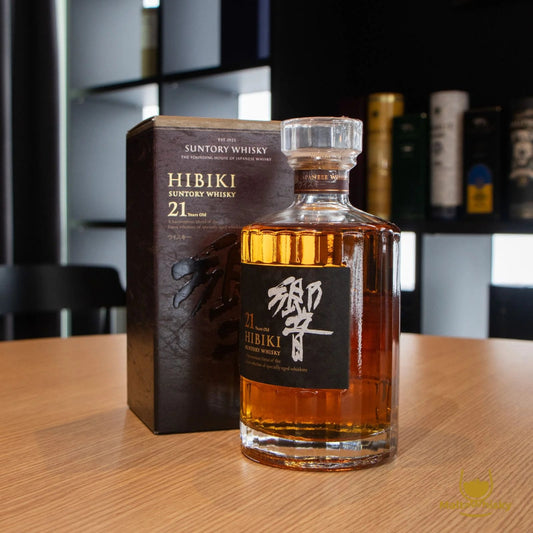 Suntory Hibiki 21-year-old whisky bottle and box on a wooden table